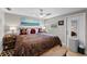 Cozy bedroom showcasing a patterned comforter, decorative pillows, and a calming, neutral color scheme at 16315 Lonely Ln, Odessa, FL 33556
