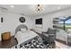 Stylish bedroom with hardwood floors, a modern light, an accent chair, and views of the pool at 16315 Lonely Ln, Odessa, FL 33556