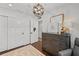 Bright bedroom features wood floors, a modern light fixture, a dresser, and neutral decor at 16315 Lonely Ln, Odessa, FL 33556