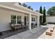 Charming front porch with rocking chairs and a stylish entrance to a modern home at 16315 Lonely Ln, Odessa, FL 33556