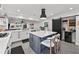 Modern kitchen featuring an island with seating, stainless appliances, and stylish cabinetry at 16315 Lonely Ln, Odessa, FL 33556
