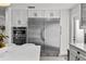 Spacious kitchen with built-in stainless steel refrigerator, double oven and bright white cabinets at 16315 Lonely Ln, Odessa, FL 33556