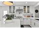 Modern kitchen with stylish white cabinets, subway tile backsplash, quartz countertops, and stainless steel appliances at 16315 Lonely Ln, Odessa, FL 33556
