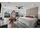 Serene main bedroom with views of the water, featuring hardwood floors and a large decorative mirror at 16315 Lonely Ln, Odessa, FL 33556