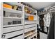 Organized walk-in closet featuring custom shelves, drawers, and hanging racks for optimal storage at 16315 Lonely Ln, Odessa, FL 33556