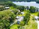 Stunning aerial view of a property with lake access and sprawling green lawns and mature trees at 16603 Hutchison Rd, Odessa, FL 33556