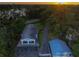 Beautiful aerial view of home with screened-in pool, detached garage, and lush green lawn at 16603 Hutchison Rd, Odessa, FL 33556