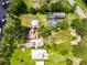 Bird's eye view of residential property featuring a pool and lush landscaping, mature trees at 16603 Hutchison Rd, Odessa, FL 33556