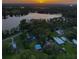 Wide aerial view of lakefront property with multiple homes and lush green landscaping at 16603 Hutchison Rd, Odessa, FL 33556