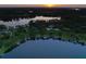 Expansive aerial view of lakefront property with multiple homes and a serene lake at 16603 Hutchison Rd, Odessa, FL 33556