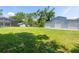 Large backyard featuring a shed, outbuilding, screened in patio and mature trees at 16603 Hutchison Rd, Odessa, FL 33556