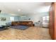 Spacious basement featuring a sectional sofa, a full size refrigerator and wood-look floors at 16603 Hutchison Rd, Odessa, FL 33556