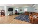 Large finished basement with sectional sofa, TV, weights and other workout equipment at 16603 Hutchison Rd, Odessa, FL 33556