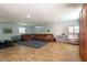 Spacious basement featuring a sectional sofa, a full size refrigerator and wood-look floors at 16603 Hutchison Rd, Odessa, FL 33556