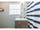 Bathroom featuring a vanity with modern finishes and a striped shower curtain at 16603 Hutchison Rd, Odessa, FL 33556