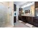 Spacious bathroom with a glass-enclosed shower and dark wood cabinetry at 16603 Hutchison Rd, Odessa, FL 33556