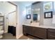 Modern bathroom featuring a vessel sink, wall-mounted mirror, and stylish fixtures at 16603 Hutchison Rd, Odessa, FL 33556