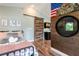 The bedrooom has light walls, vaulted ceiling, sliding barn door, and wood floors at 16603 Hutchison Rd, Odessa, FL 33556