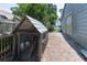 Chicken coop with water buckets and trough sitting on a dirt lot adjacent to a shed at 16603 Hutchison Rd, Odessa, FL 33556
