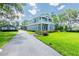 Beautiful two-story home featuring a spacious driveway, lush lawn, and a separate matching guest house at 16603 Hutchison Rd, Odessa, FL 33556