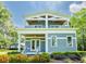 Inviting two-story home featuring a welcoming front porch and well-maintained flower beds at 16603 Hutchison Rd, Odessa, FL 33556