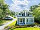 Charming two-story home with a welcoming front porch and well-manicured lawn and a detached garage at 16603 Hutchison Rd, Odessa, FL 33556