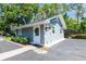 Charming gray in-law suite featuring lovely landscaping and plenty of parking space at 16603 Hutchison Rd, Odessa, FL 33556