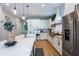 Modern kitchen features white cabinets, stainless steel appliances, a large island, and pendant lighting at 16603 Hutchison Rd, Odessa, FL 33556