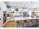 Modern kitchen with white cabinets, stainless steel appliances, and a large center island at 16603 Hutchison Rd, Odessa, FL 33556