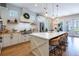 Modern kitchen with white cabinets, stainless steel appliances, a large island and pendant lighting at 16603 Hutchison Rd, Odessa, FL 33556