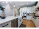 Bright kitchen featuring a large island, stainless steel appliances, white cabinets, and hardwood floors at 16603 Hutchison Rd, Odessa, FL 33556