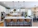 Bright kitchen with white cabinets, a large center island with seating and stainless steel appliances at 16603 Hutchison Rd, Odessa, FL 33556