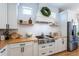 This kitchen boasts wooden countertops, white cabinets, stainless steel appliances, and decorative shelving at 16603 Hutchison Rd, Odessa, FL 33556