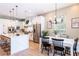Open-concept kitchen and dining area with a large island, stainless steel appliances, and modern lighting at 16603 Hutchison Rd, Odessa, FL 33556