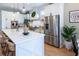Kitchen featuring white cabinets, stainless steel appliances, and a large center island with seating at 16603 Hutchison Rd, Odessa, FL 33556