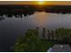 Beautiful lake at sunset, surrounded by lush trees and visible from the property at 16603 Hutchison Rd, Odessa, FL 33556