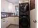 Efficient laundry room with stacked washer and dryer, plus cabinet storage at 16603 Hutchison Rd, Odessa, FL 33556