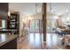 Bright living room featuring vaulted ceilings, hardwood floors, and access to a balcony at 16603 Hutchison Rd, Odessa, FL 33556