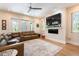Comfortable living room with a leather sectional, fireplace, and access to the outdoor area at 16603 Hutchison Rd, Odessa, FL 33556