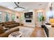 Spacious living room features a large sectional, modern fireplace, and abundant natural light at 16603 Hutchison Rd, Odessa, FL 33556