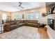 Open living space with a sectional sofa, fireplace, and connection to the dining area and outdoors at 16603 Hutchison Rd, Odessa, FL 33556
