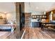 Open living area with kitchenette and bed with a view of the sliding barn door at 16603 Hutchison Rd, Odessa, FL 33556