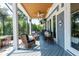 Screened-in porch features comfortable wicker seating and a ceiling fan at 16603 Hutchison Rd, Odessa, FL 33556