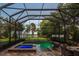 Stunning screened-in pool and spa area with elegant brick paving and lush landscaping at 16603 Hutchison Rd, Odessa, FL 33556