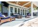 Relaxing covered porch with comfortable seating, ceiling fans and access to backyard and water views at 16603 Hutchison Rd, Odessa, FL 33556