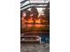 Sunset view from screened in patio overlooking a pool, lake and mature trees at 16603 Hutchison Rd, Odessa, FL 33556