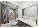 Bathroom with tub and tiled shower, granite-look countertop, and large mirror at 1700 Ironwood E Ct, Oldsmar, FL 34677