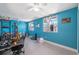 Bright bonus room with neutral floors, two windows, and ceiling fans at 1700 Ironwood E Ct, Oldsmar, FL 34677