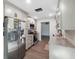 Modern renovated kitchen with stainless steel appliances, gray cabinets, and granite countertops at 1700 Ironwood E Ct, Oldsmar, FL 34677