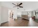 Open-concept living room with modern floors and a ceiling fan leading to a renovated kitchen at 1700 Ironwood E Ct, Oldsmar, FL 34677